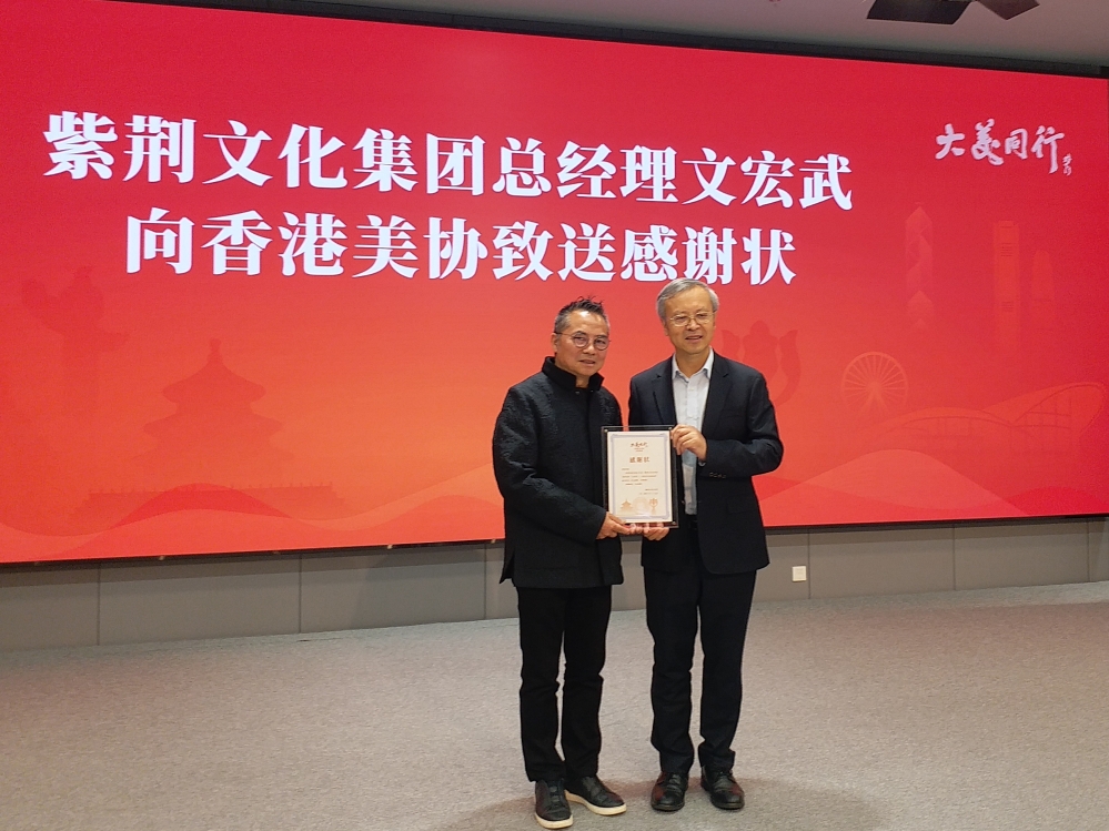 紫荆文化集团总经理文宏武(右)向香港美协赠送感谢状 紫荆文化集团总经理文宏武(右)向香港美协赠送感谢状