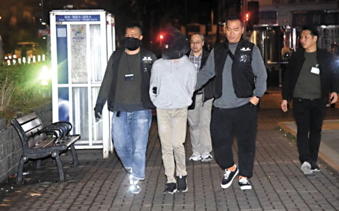 涉枪械案弃保潜逃的“屠龙小队”成员,被黑布蒙头押返警署扣查。(资料图片) 截屏2024-05-15 上午11.53.18