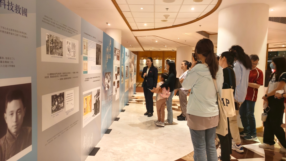 观众入场前驻足观看钱学森事迹展板 1118560994